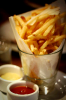 Fries in a glass with ketchup & meyo on the side.png