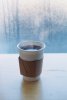 Paper cup of black coffee, winter in the backround.jpg