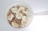 Granola with banana slices and milk.png