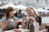 9030706-very-cute-smiling-women-drinking-a-coffee-sitting-outside-in-a-cafe-bistro.jpg