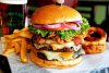 Perfect cheeseburger with fries, onion rings adn dark beer.jpg