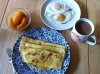 Norwegian pancakes with honey, eggs, sliced peaches and coffee.jpg