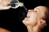 6039818-young-thirsty-girl-drinking-water-from-a-bottle-isolated-on-black-background.jpg